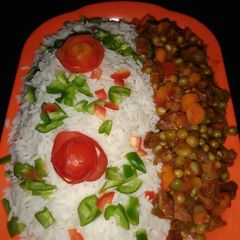A picture of White rice and veggies sauce.