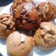 A picture of Muffins with peanuts and raisins.