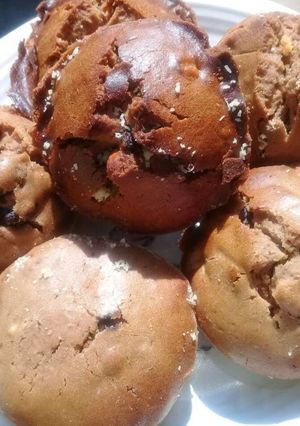 A picture of Muffins with peanuts and raisins.