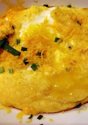 A picture of Cheesy breakfast polenta with eggs.