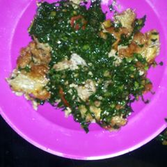 A picture of Fried eggs and sukuma wiki.
