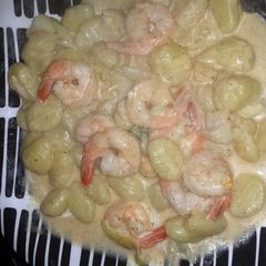 A picture of shrimp and scallop in a creamy garlic butter sauce.