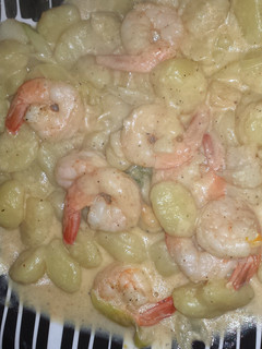 A picture of shrimp and scallop in a creamy garlic butter sauce.