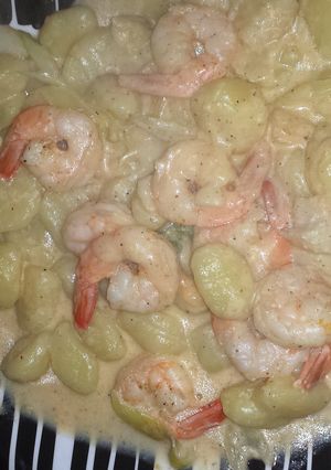 A picture of shrimp and scallop in a creamy garlic butter sauce.