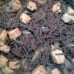 A picture of black rice noodle and pork.