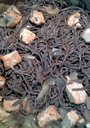 A picture of black rice noodle and pork.