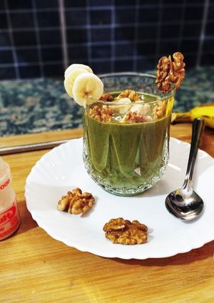 A picture of Banana Moringa Yakult Milkshake topped with Walnuts.