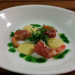 PROSCIUTTO wrapped PRAWNS, CORN PUREE + PESTO OIL A picture of PROSCIUTTO wrapped PRAWNS, CORN PUREE + PESTO OIL.