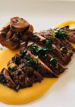 A picture of Chuck steak over a butternut puree and sauted mushrooms.