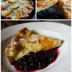 A picture of Peach Dutch Baby with Blueberry Compote.