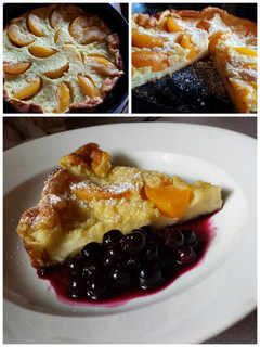 A picture of Peach Dutch Baby with Blueberry Compote.