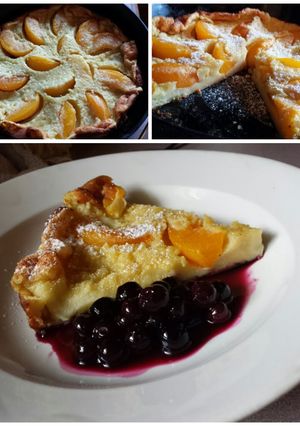 A picture of Peach Dutch Baby with Blueberry Compote.
