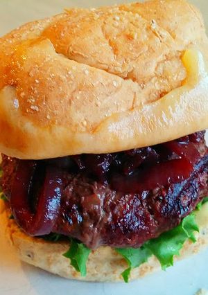 A picture of Bison Burgers with Cabernet Onions and Wisconsin Cheddar.
