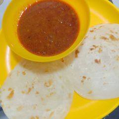 A picture of Kala chana curry with mini malabar paratha.