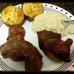 A picture of Honey BBQ ribs with cheese bread.