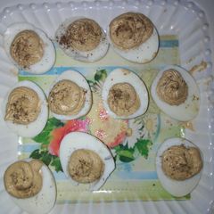 A picture of Deviled eggs garnish with black papper.