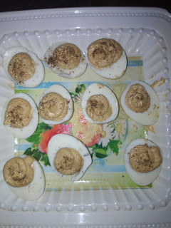 A picture of Deviled eggs garnish with black papper.