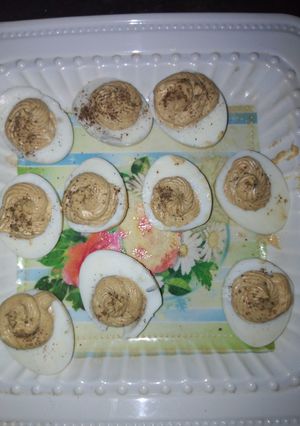 A picture of Deviled eggs garnish with black papper.