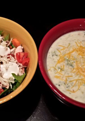 A picture of Cream of broccoli soup with cheese.