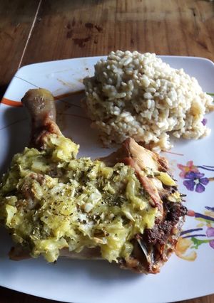 Una foto de Pollo al horno con cebollas y arroz con crema como guarnición