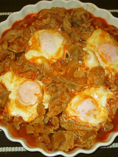 A picture of Pork and Eggs with Ketchup.