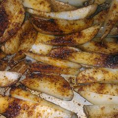 A picture of spicy potato wedges.