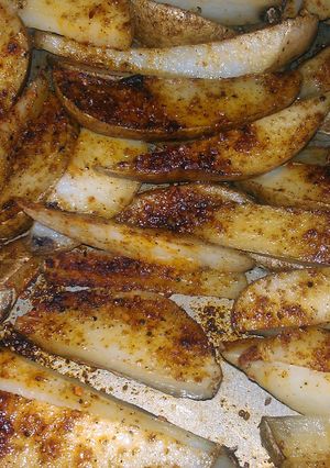 A picture of spicy potato wedges.