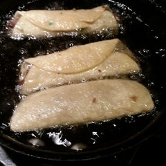 A picture of Flautas with green salsa.