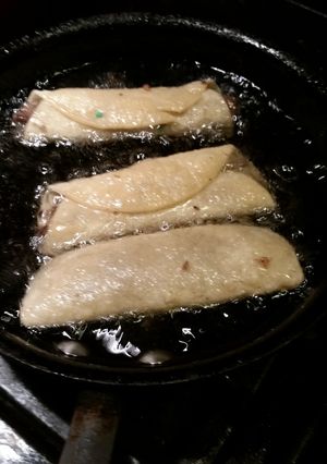 A picture of Flautas with green salsa.