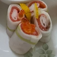 A picture of Salmon roll with pickles thin-sliced turnips.
