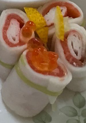 A picture of Salmon roll with pickles thin-sliced turnips.