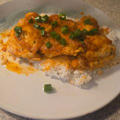 A picture of Pan-Seared Chicken Thighs with Roasted Red Pepper Sauce.