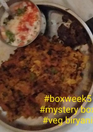 A picture of Veg biryani and onion tomato raita.