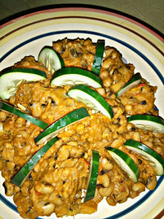 A picture of Beans and yam porridge with cucumber.