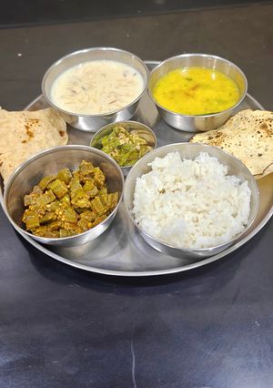 A picture of Maharashtrian Thali For Lunch -Fry Bhindi, Bhhat,Varan, Kharda, Chapati, Kheer.
