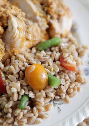 A picture of Chicken Breasts Stuffed with Herbed Goat Cheese and Piccolo Farroto with Tomatoes and Romano Bean Salad.