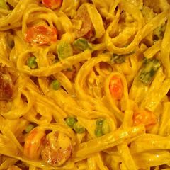 A picture of Fettuccine Alfredo with sausage and veggies.