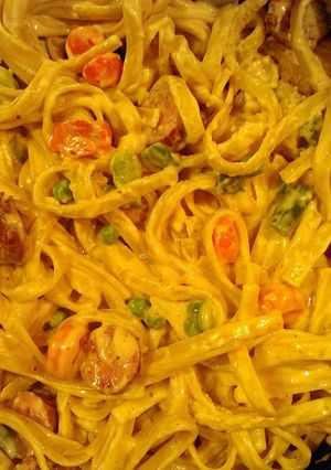 A picture of Fettuccine Alfredo with sausage and veggies.