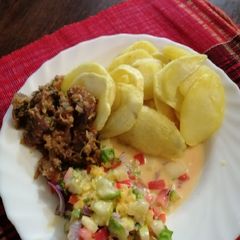 A picture of Roasted potatoes, kachumbari in castor milk and fried beef.