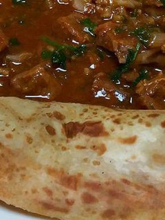 A picture of Stewed Beef served with chapati.