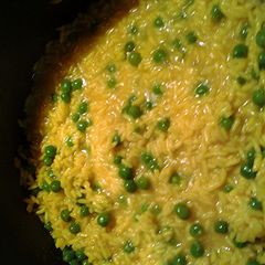 A picture of tumeric rice with peas.