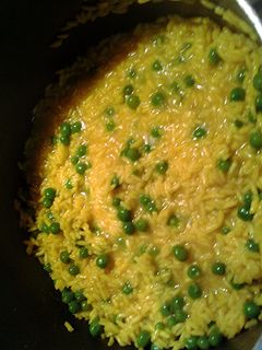 A picture of tumeric rice with peas.