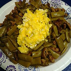 A picture of Green beans with jalapeño, sausage and eggs.