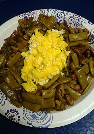 A picture of Green beans with jalapeño, sausage and eggs.