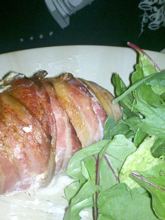 A picture of Bacon wrapped stuffed chicken breast.
