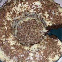 A picture of Chocolate Cake with Cream Cheese Icing & Chocolate Shavings.