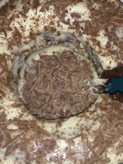 A picture of Chocolate Cake with Cream Cheese Icing & Chocolate Shavings.
