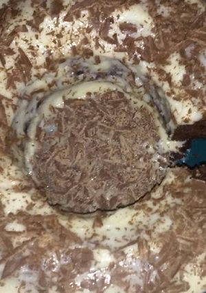 A picture of Chocolate Cake with Cream Cheese Icing & Chocolate Shavings.