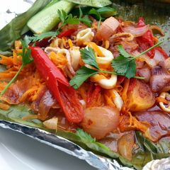 A picture of Baked Spicy Calamari / Squid (BANANA LEAF WRAP ).