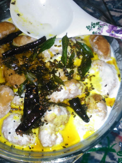A picture of Dahi wada ( fried lentil balls in yoghurt).